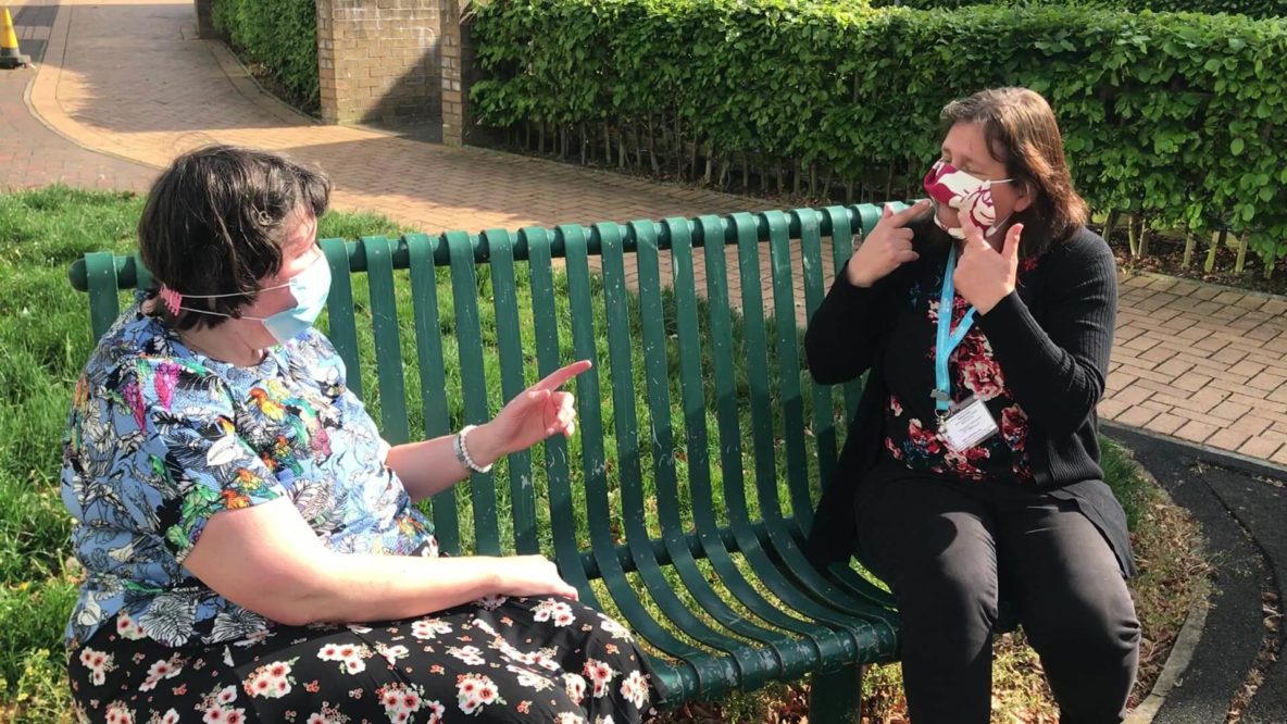 Women wearing clear masks to communicate