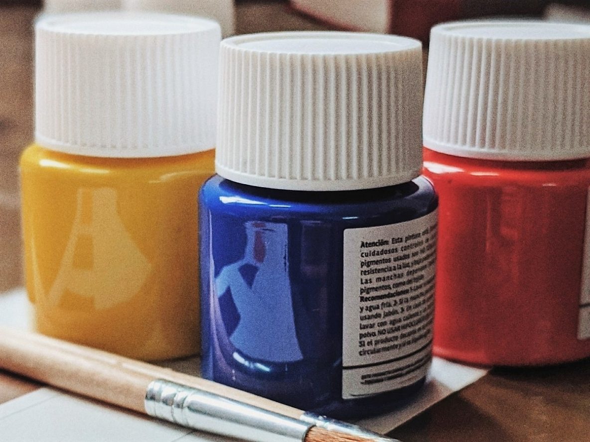 Colourful paint pots and brushes