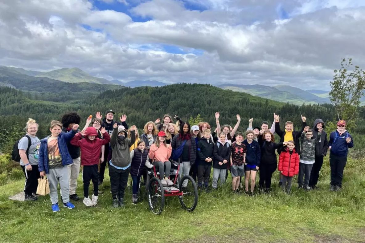 Deaf Action Youth camp group photo ontop of a hill viewpoint
