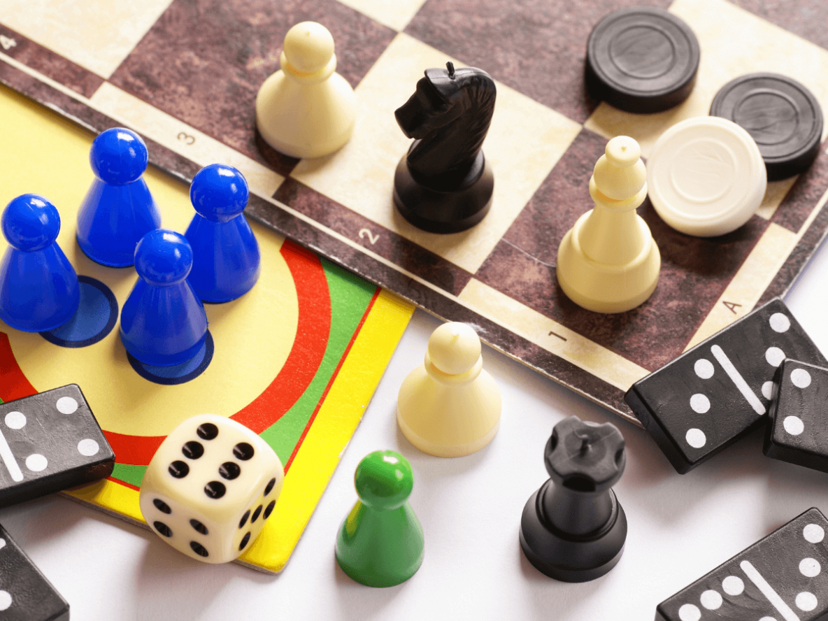 Board games, dice and coloured game pieces